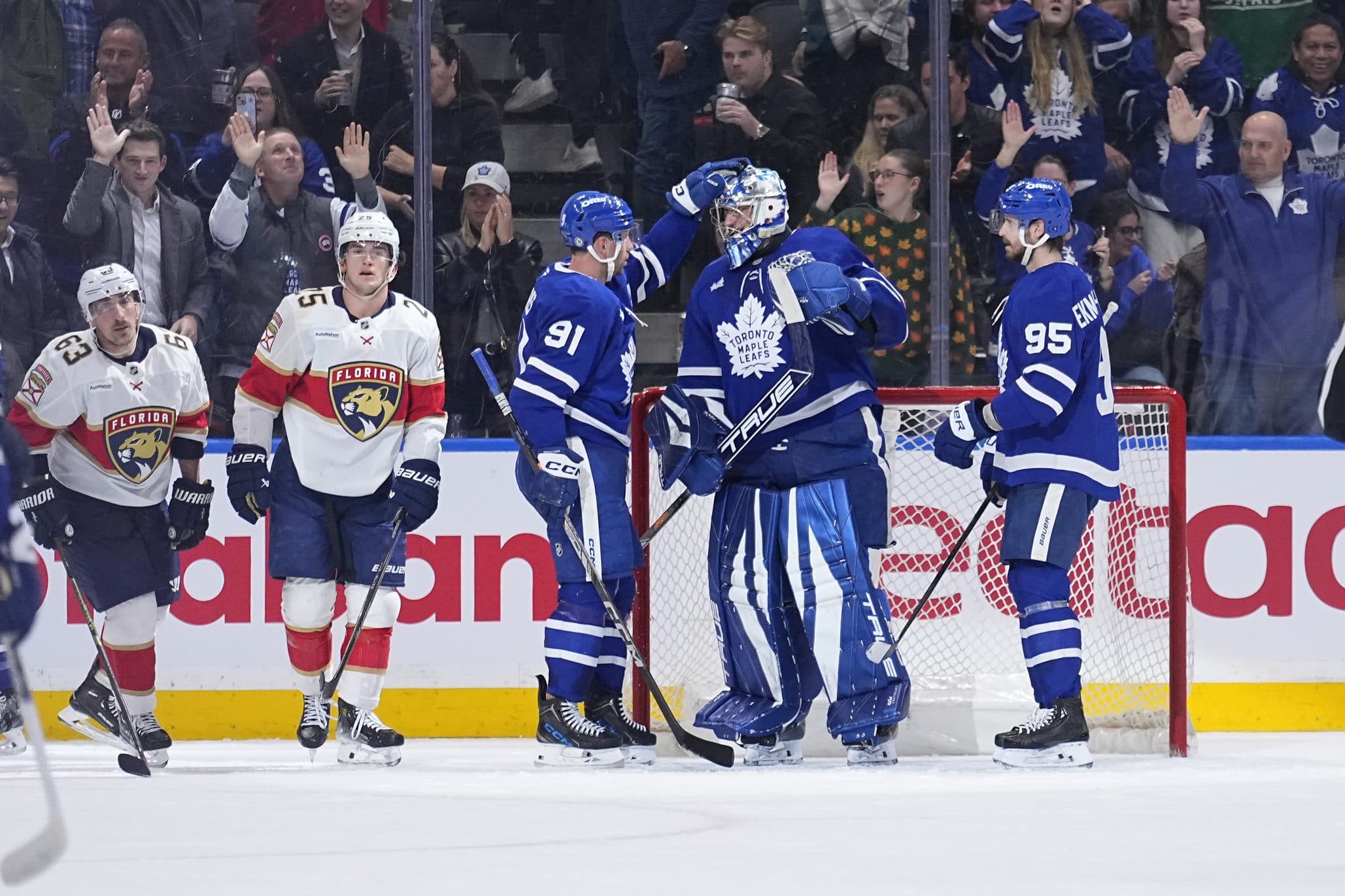 Toronto Maple Leafs forward John Tavares (91) and defenseman Oliver Ekman-Larsson (95) congratulate goaltender Anthony Stolarz (41) after a win against the Florida Panthers at Scotiabank Arena.