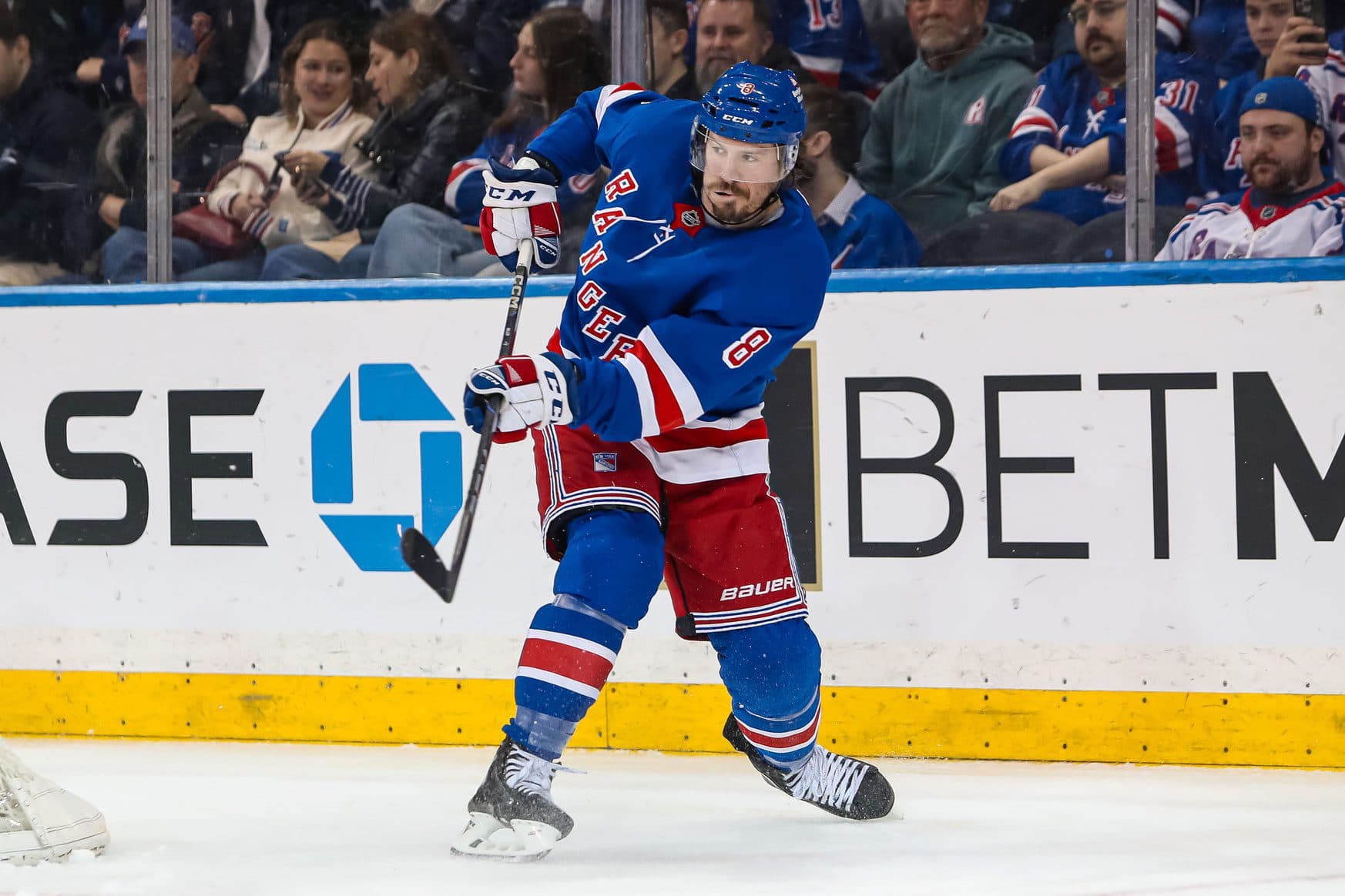 New York Rangers center J.T. Miller (8) clears the puck against the Vancouver Canucks during the second period at Madison Square Garden.