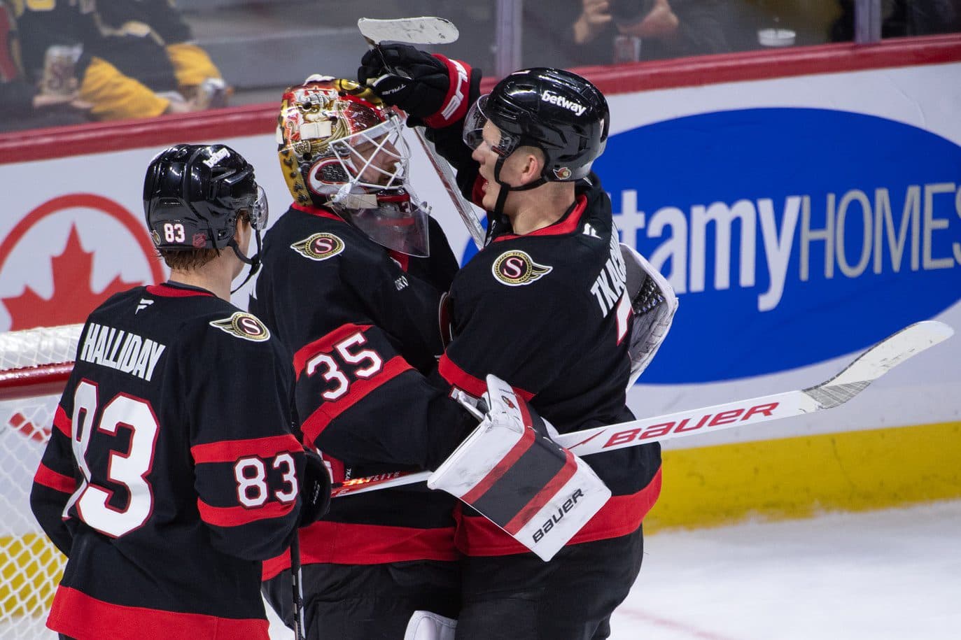Ottawa Senators goalie Linus Ullmark (35) is congratulated by left wing Brady Tkachuk (7) after a shutout against the Pittsburgh Penguins at the Canadian Tire Centre.