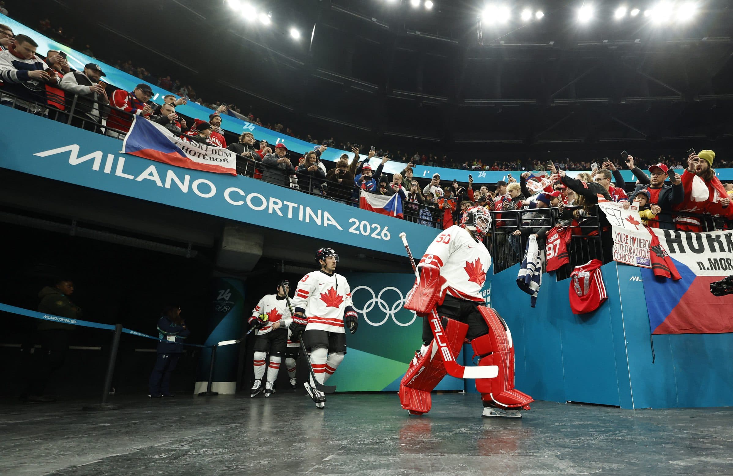 Jordan Binnington of Canada leads the team to the ice before the match against Czechia in a men's ice hockey group A match during the Milano Cortina 2026 Olympic Winter Games at Milano Santagiulia Ice Hockey Arena.