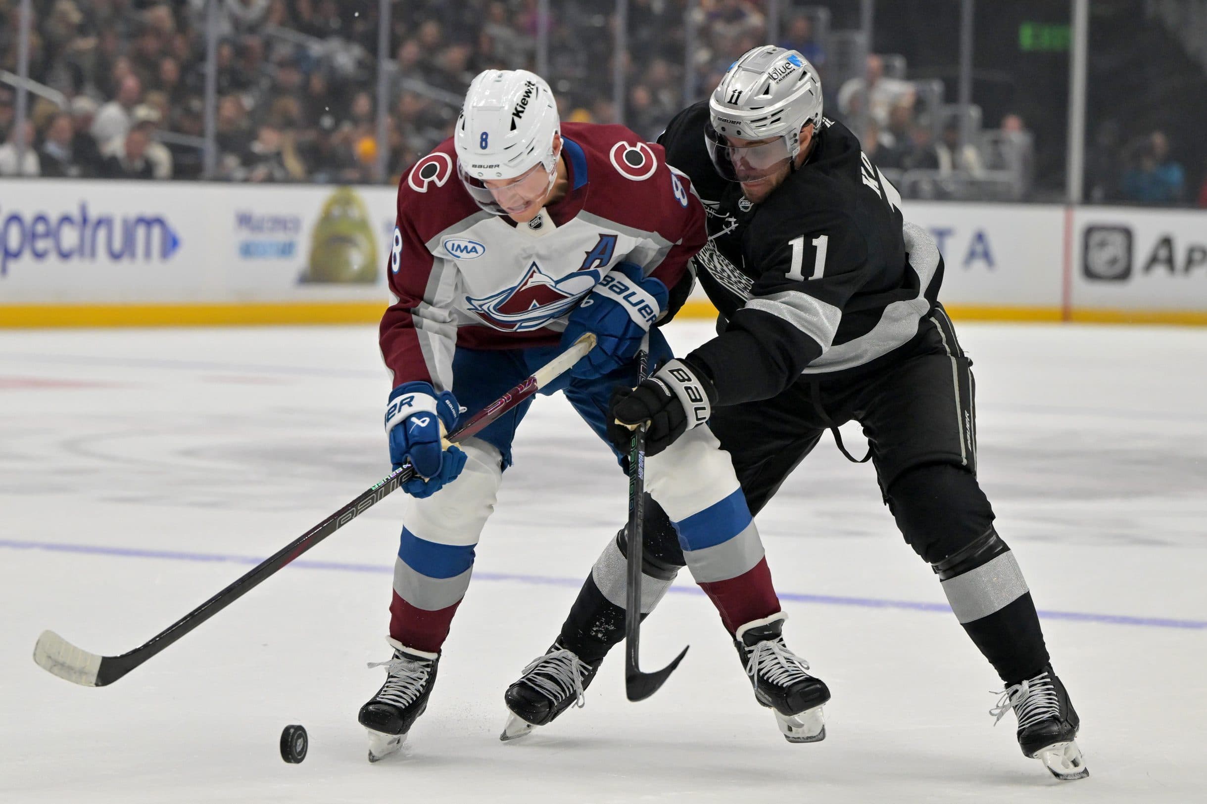 Colorado Avalanche defenseman Cale Makar (8) and Los Angeles Kings center Anze Kopitar (11) battle for the puck during the first period at Crypto.com Arena.