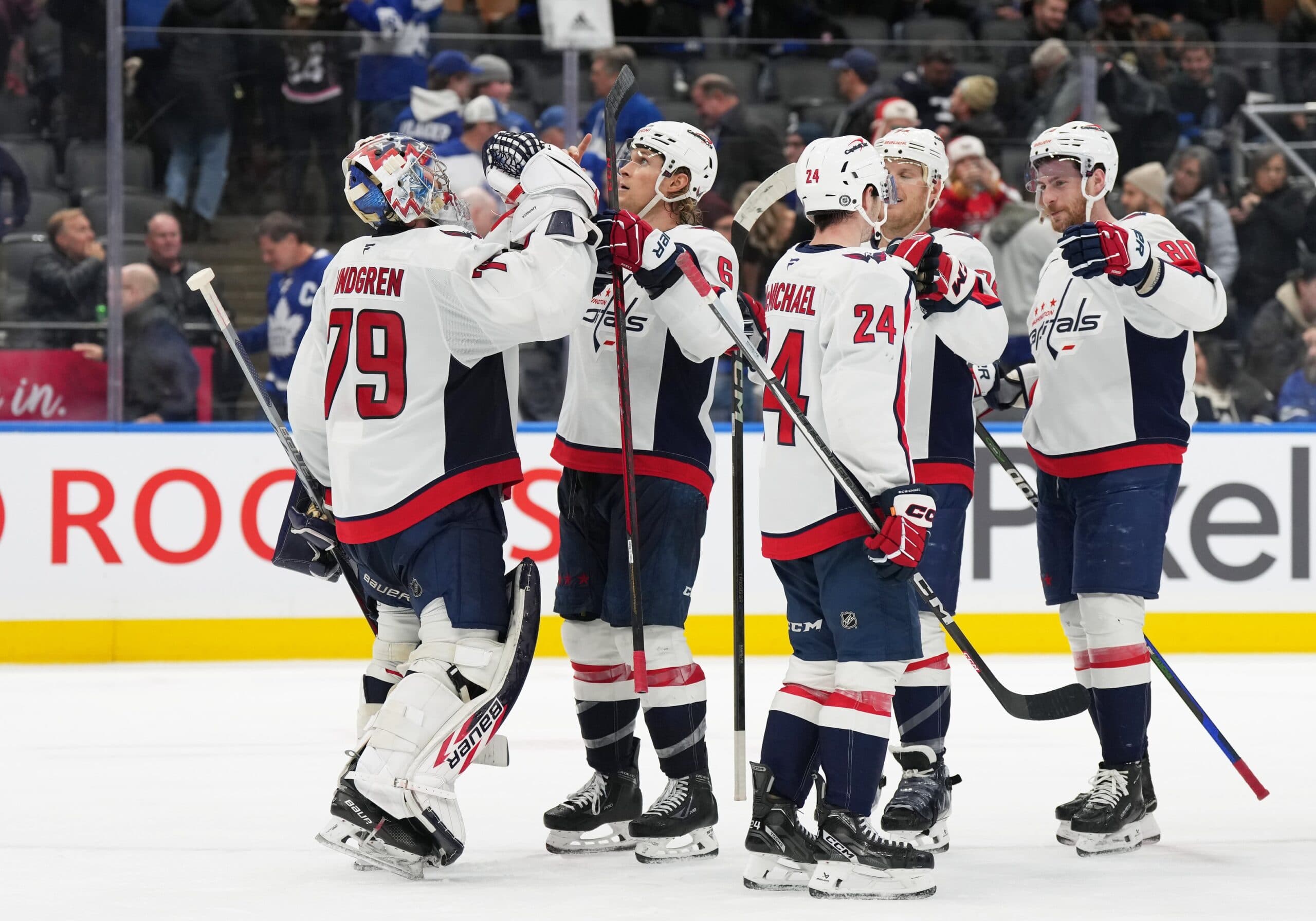 Washington Capitals defenseman Jakob Chychrun (6) celebrates the win with goaltender Charlie Lindgren (79) against the Toronto Maple Leafs at the end of the third period at Scotiabank Arena.