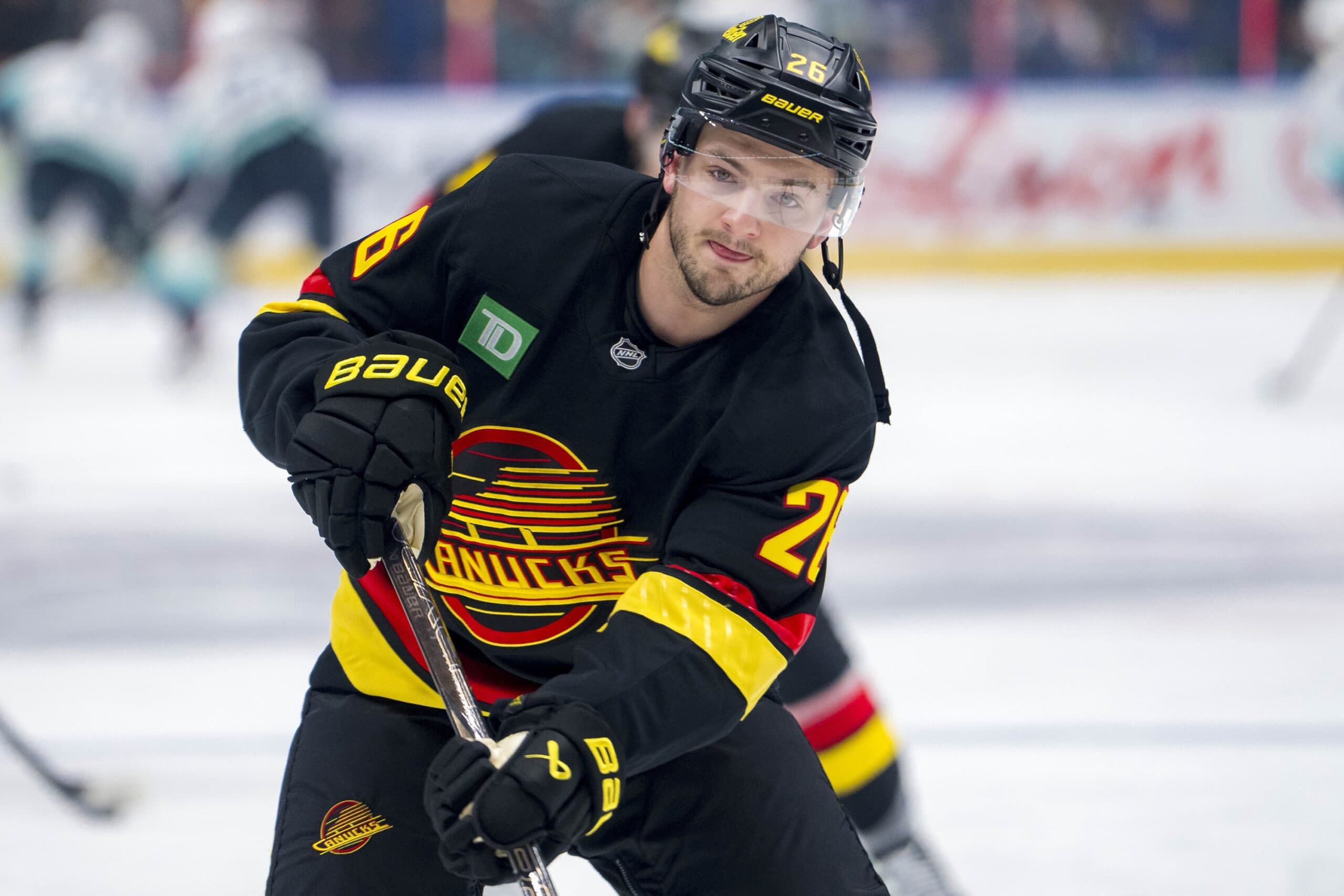 Vancouver Canucks defenseman Erik Brannstrom (26) shoots during warm up prior to a game against the Seattle Kraken at Rogers Arena.