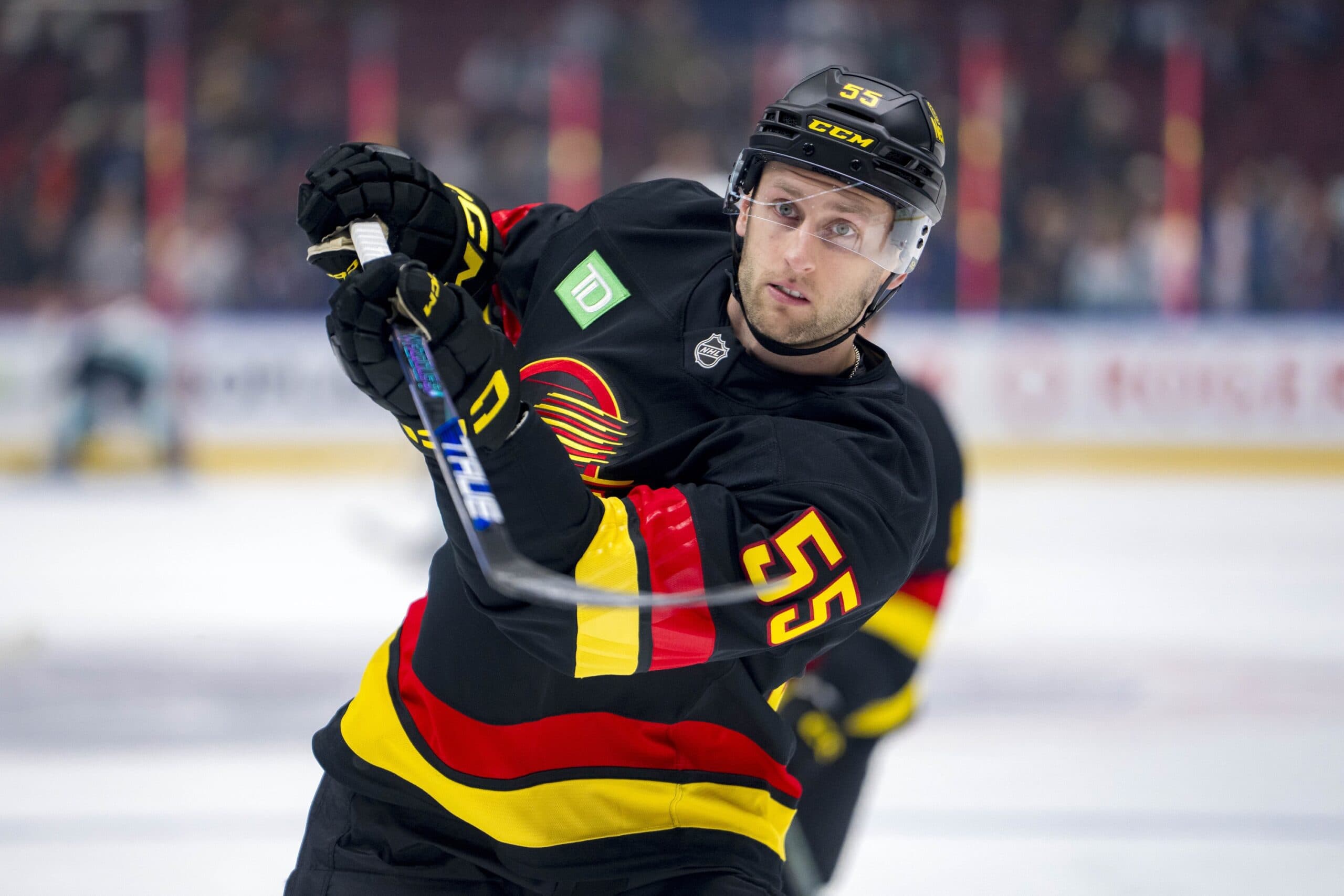 Vancouver Canucks defenseman Guillaume Brisebois (55) shoots during warm up prior to a game against the Seattle Kraken at Rogers Arena.