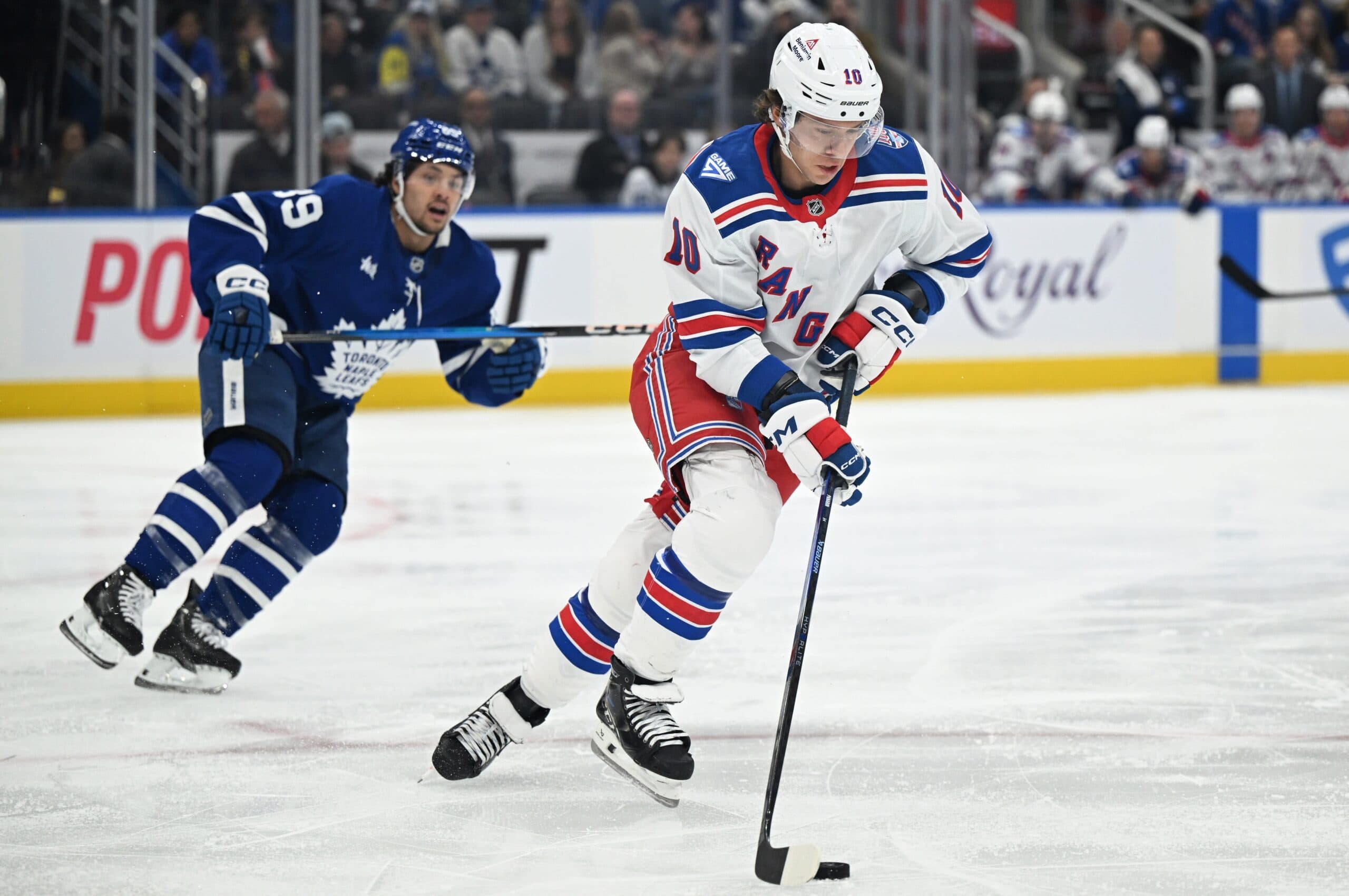 New York Rangers forward Artemi Panarin (10) skates the puck away from Toronto Maple Leafs forward Nick Robertson (89) in the first period at Scotiabank Arena.