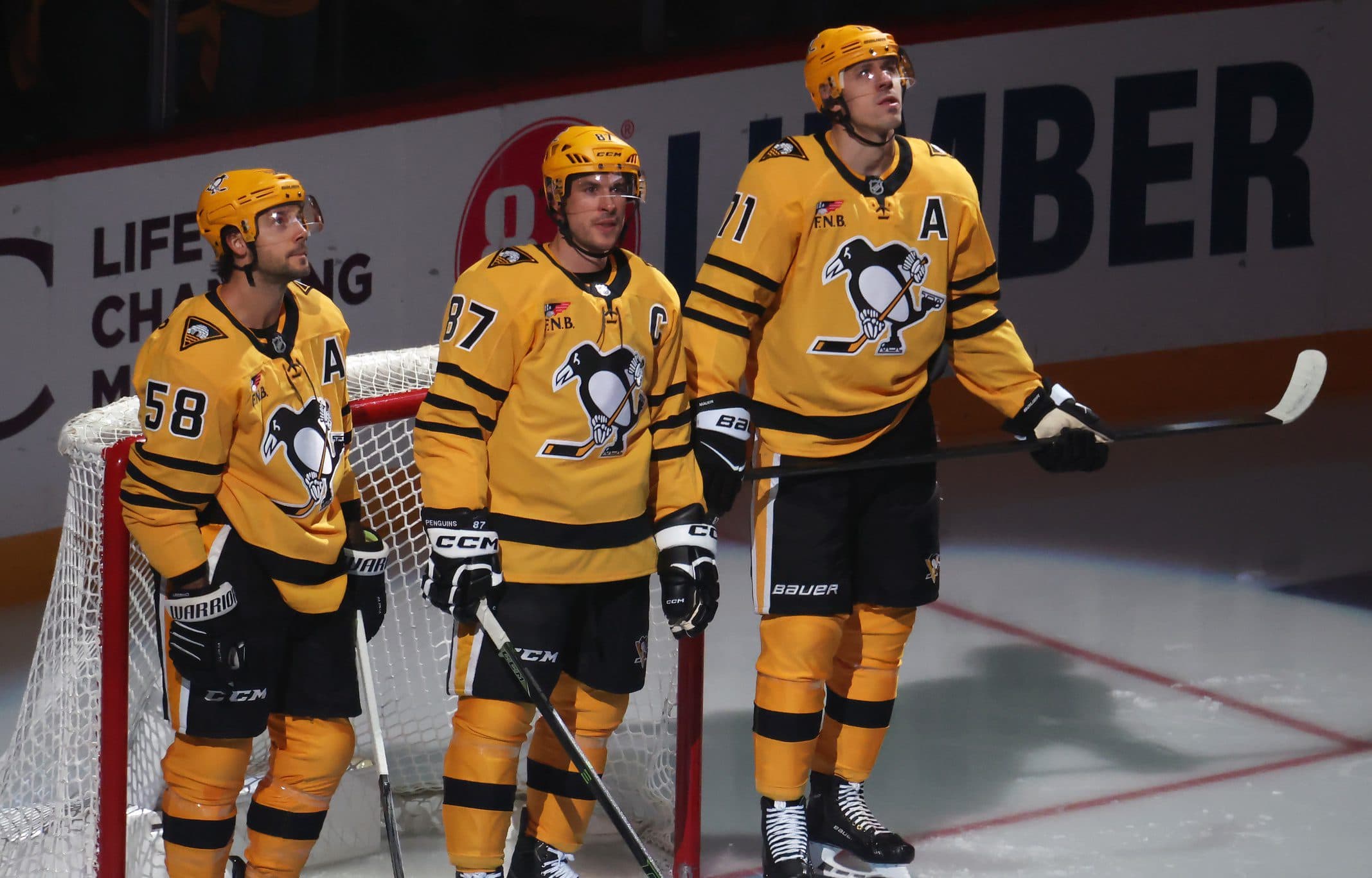 Pittsburgh Penguins defenseman Kris Letang (58) and center Sidney Crosby (87) and center Evgeni Malkin (71) stand as they are recognized as the longest tenured teammates in North American professional sports history before their twentieth season together prior to the game against the New York Islanders at PPG Paints Arena.